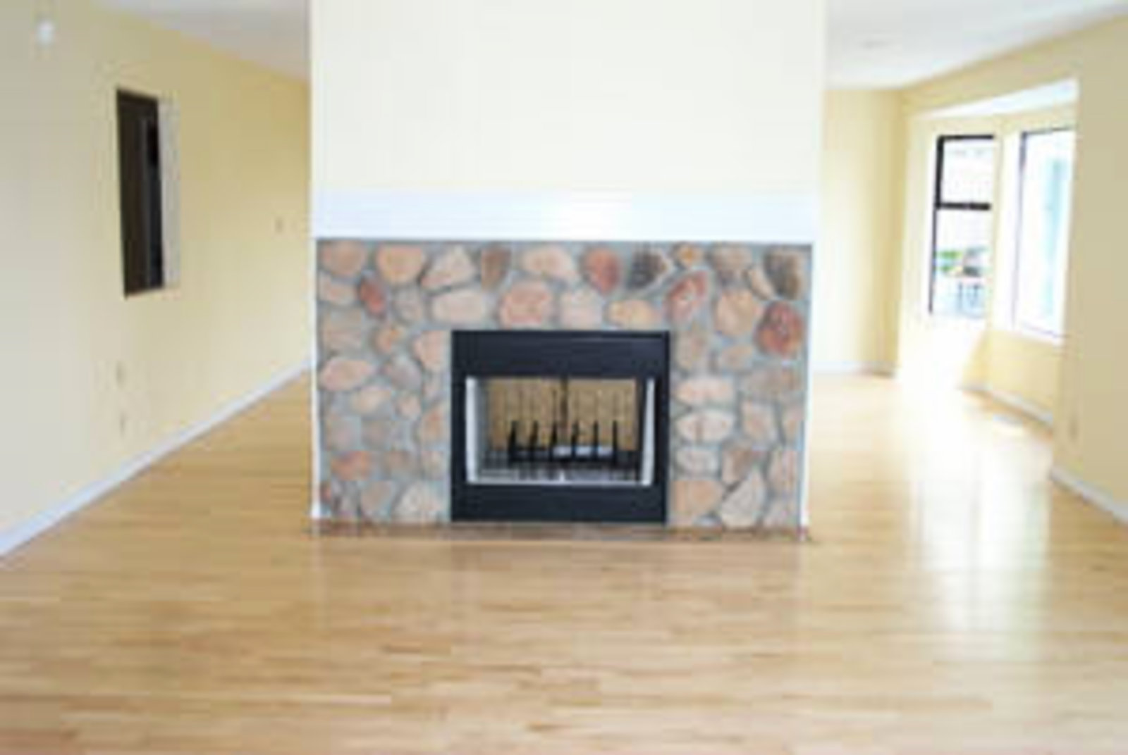 Family Room Connects with kitchen, birchwood floors, wood burning fireplace.